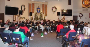 West Valley Crescendo Choir performs during the Jingle & Jive holiday concert at Benevilla, surrounded by festive decorations and community members